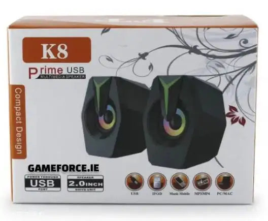 SPEAKER PRIME USB K8 GAMING SPEAKERS showing compact design with RGB lighting on a gaming desktop setup